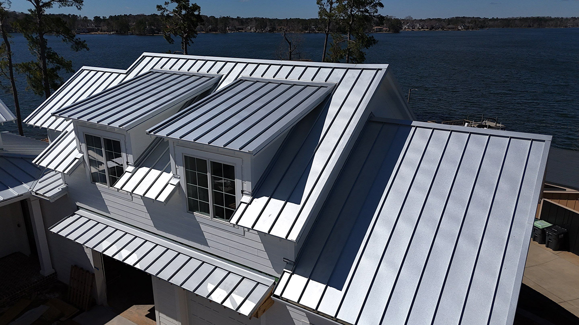 House with a sleek metal roof, highlighting a modern and durable roofing material.